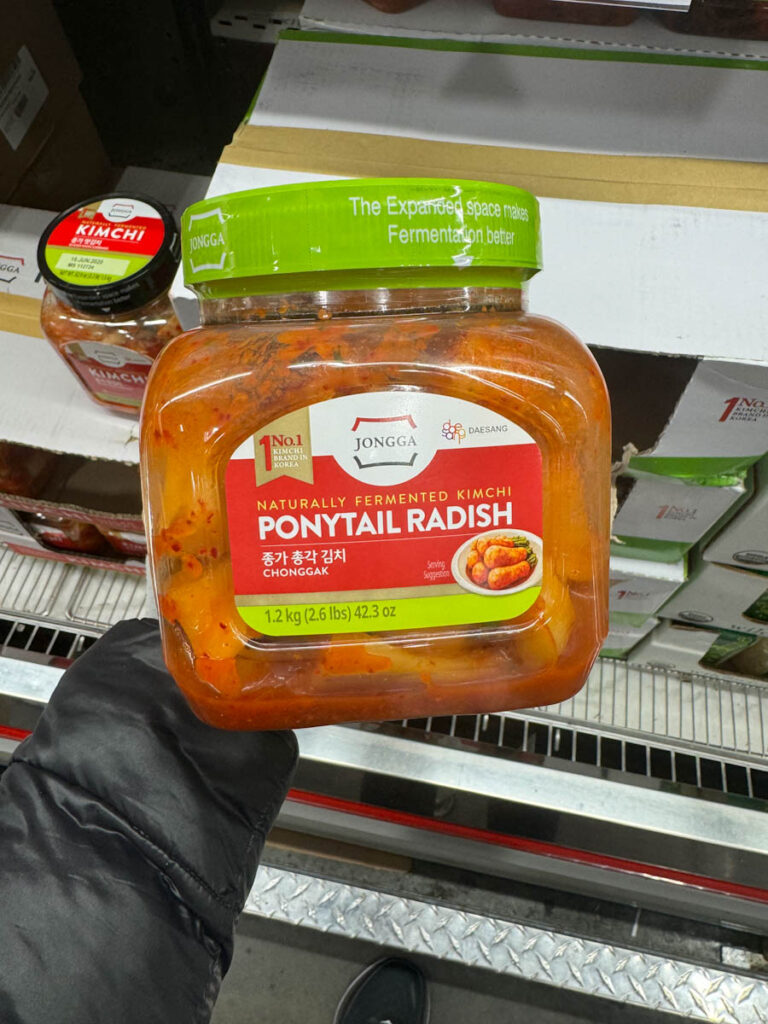 a package of costco ponytail radish in hand