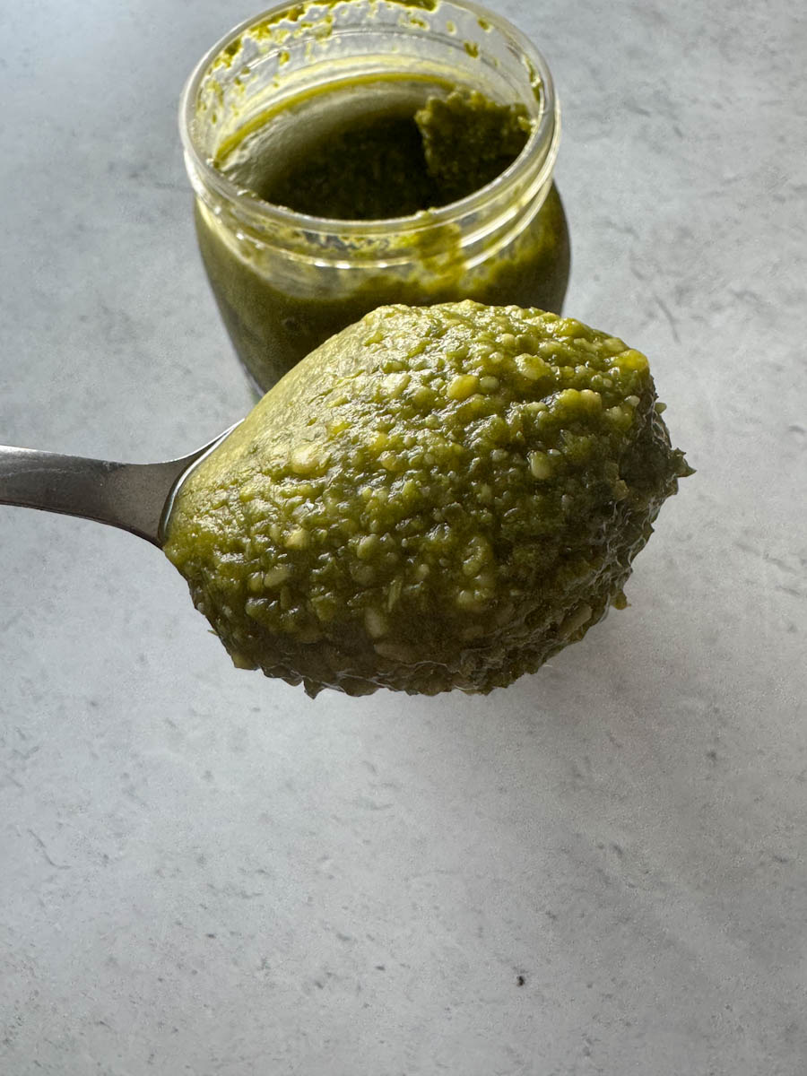 a scoop of pesto in the spoon