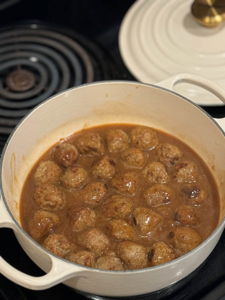 meatballs with gravy in the white pot