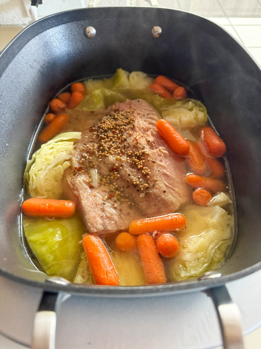 Costco corned beef with cabbage and carrots in the pot