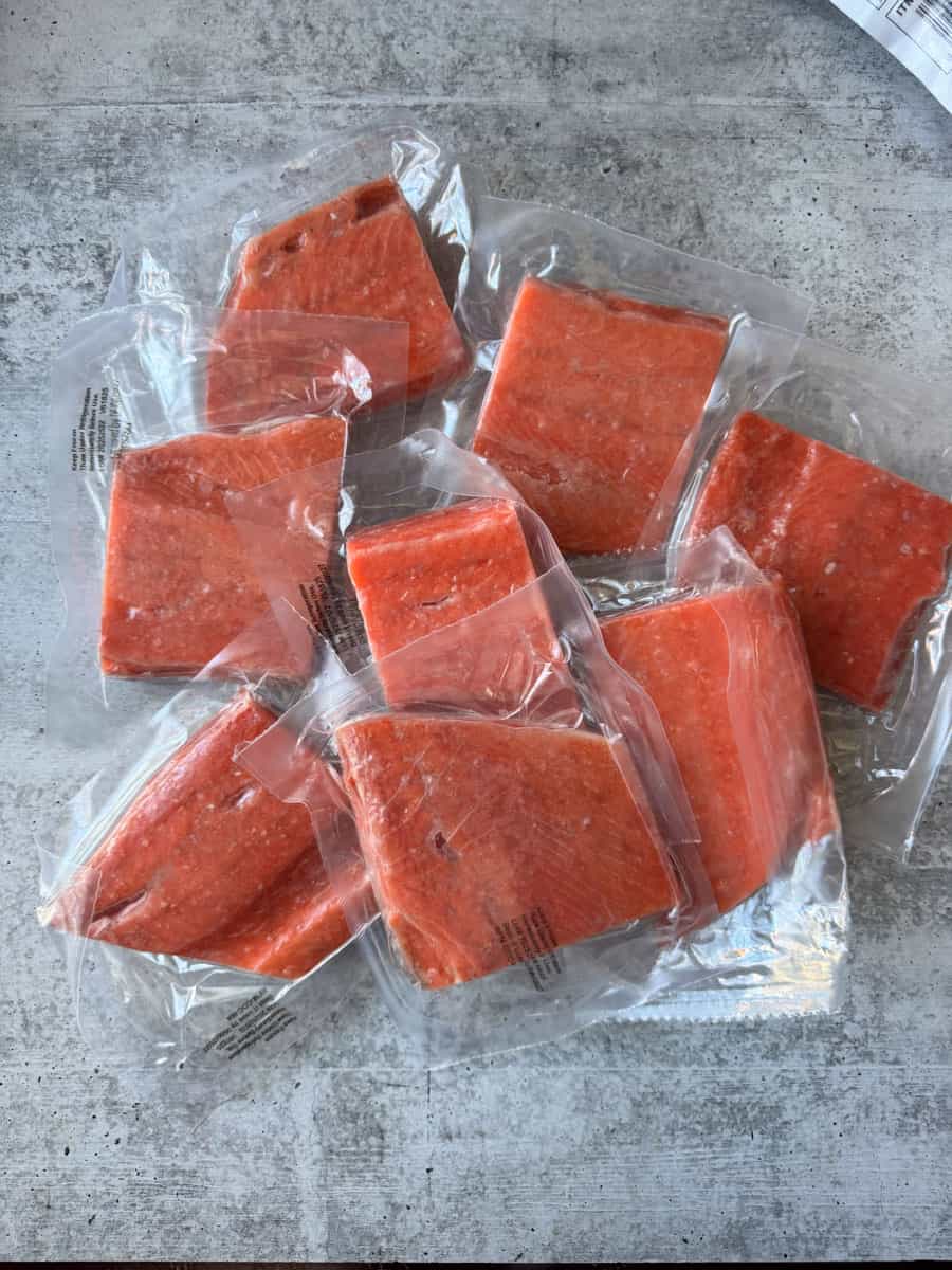 few frozen salmon fillets vacuum sealed on the table