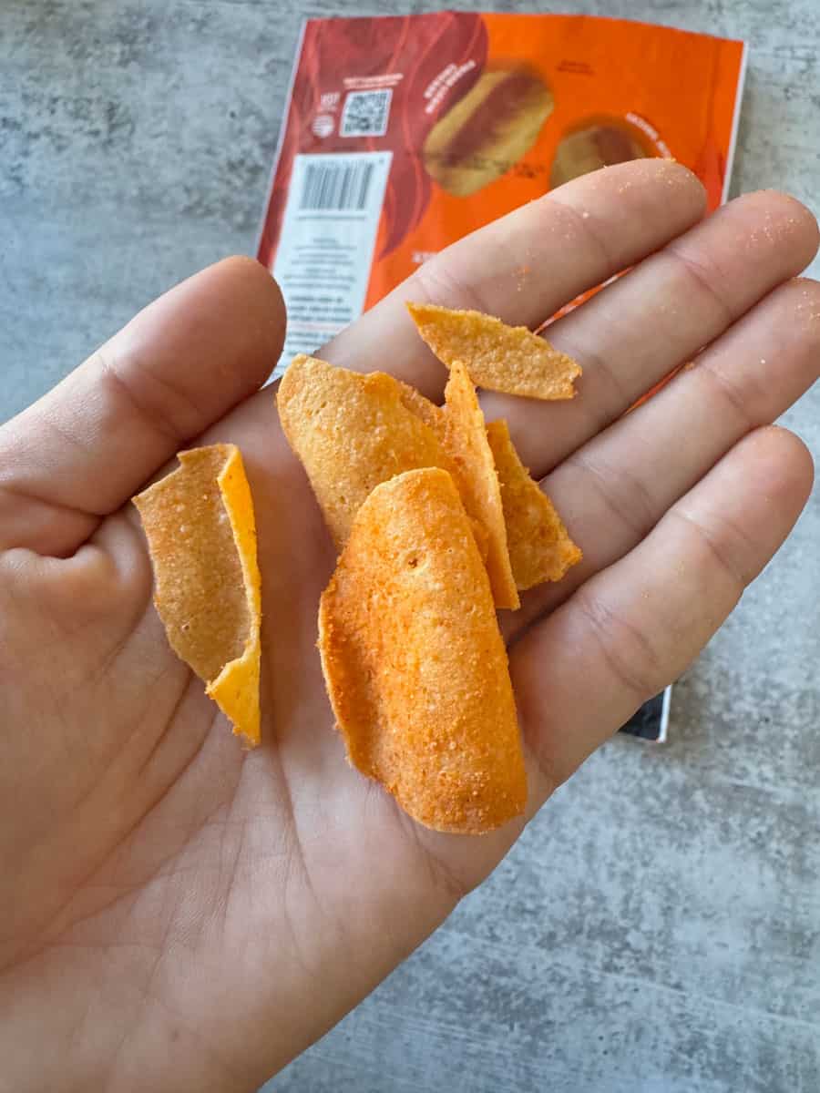 Crispy chicken nuggets from Costco in hand, ready to eat.