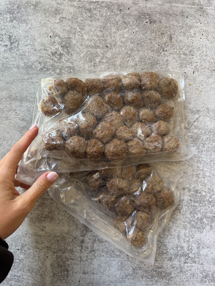 Frozen meatballs in vacuum-sealed bags at Costco store.