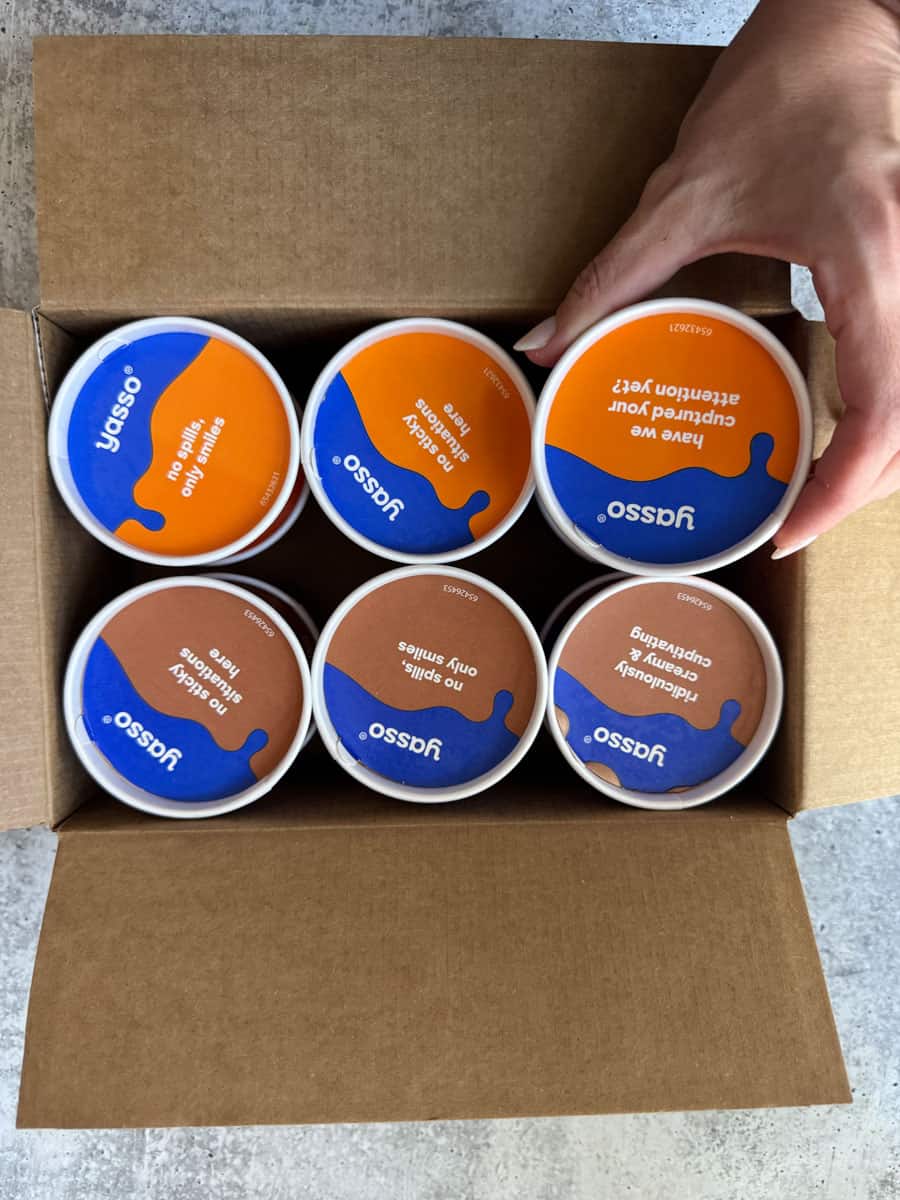 Six containers of Jussco skincare products in a cardboard box.