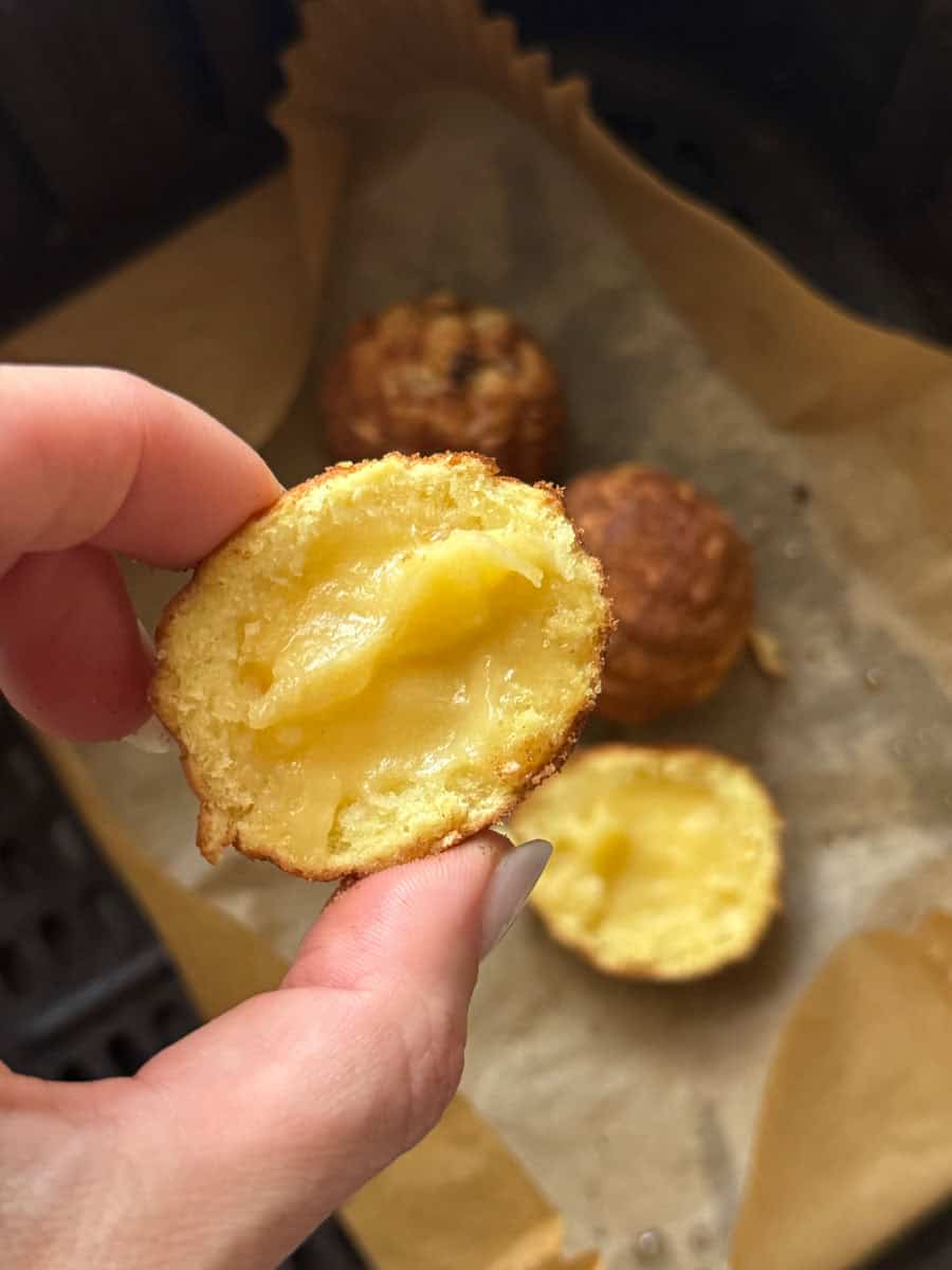 Delicious cheese-filled potato balls, freshly baked and golden brown, perfect for snack or appetizer.
