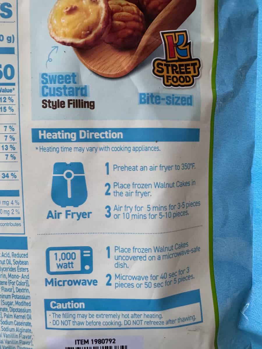 Close-up of sweet custard bite-sized muffins with heating instructions on packaging.