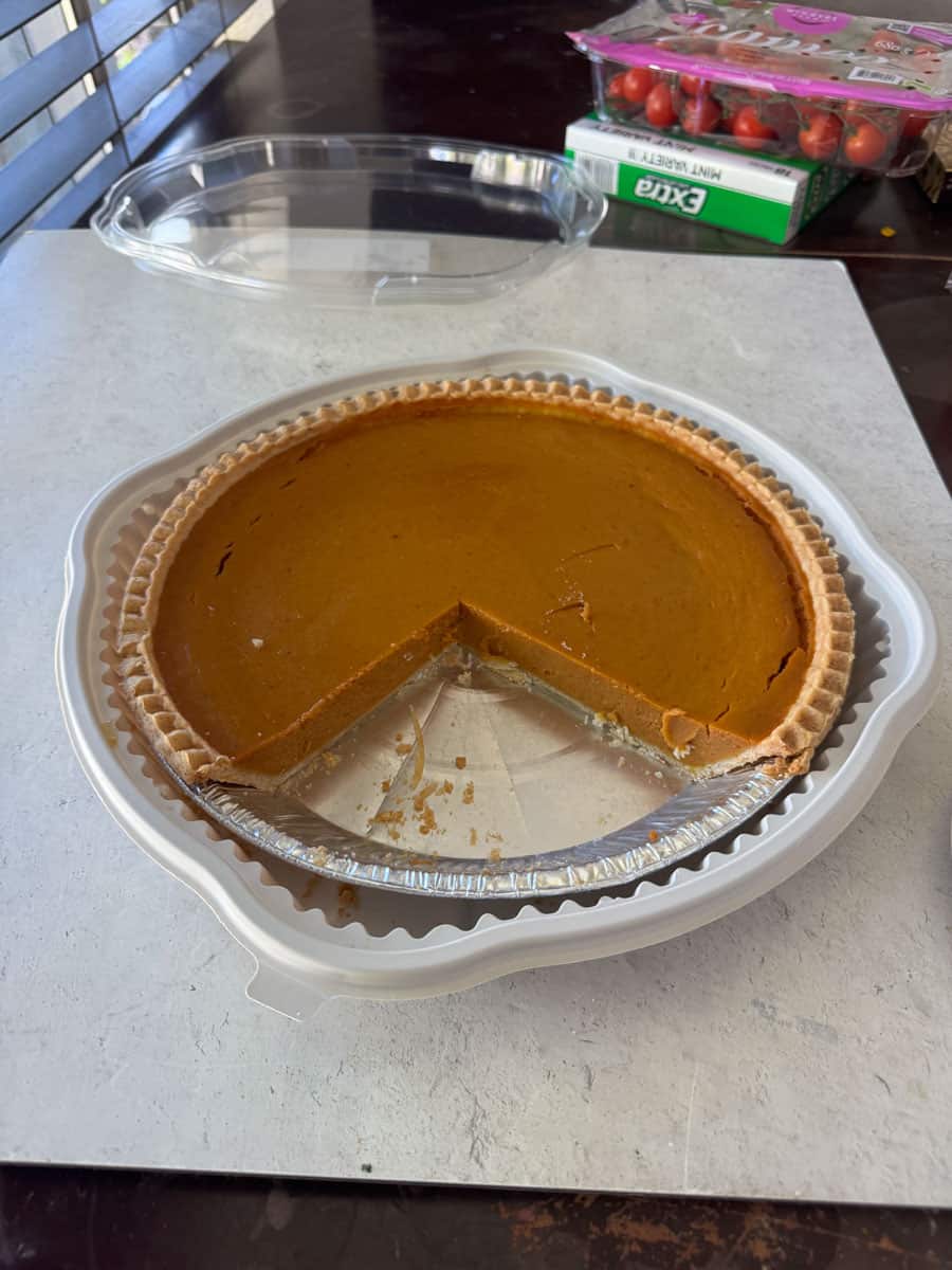 Delicious pumpkin pie from Costco with a slice removed.