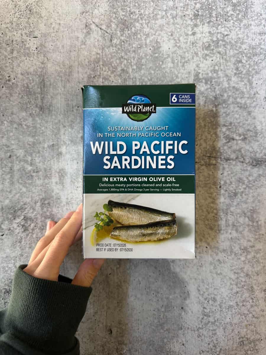Wild Planet Wild Pacific Sardines in extra virgin olive oil can box on concrete.