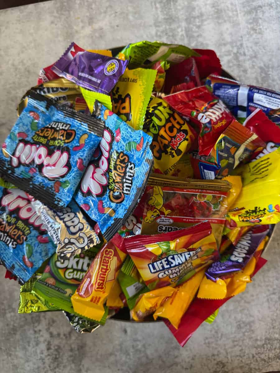 Assorted colorful candy wrappers in a pile.